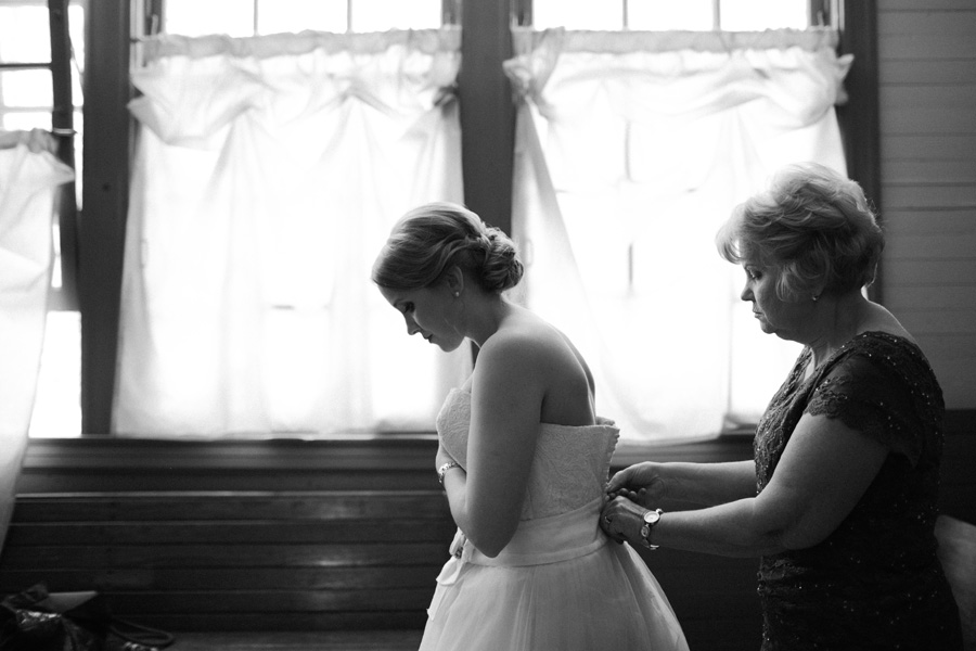 bride putting on dress