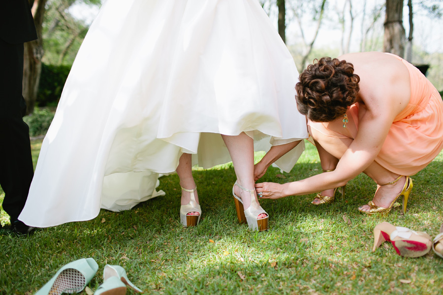helping bride with shoes