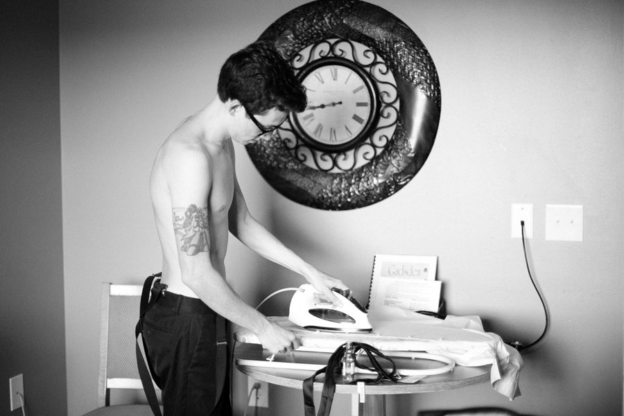 groom ironing shirt